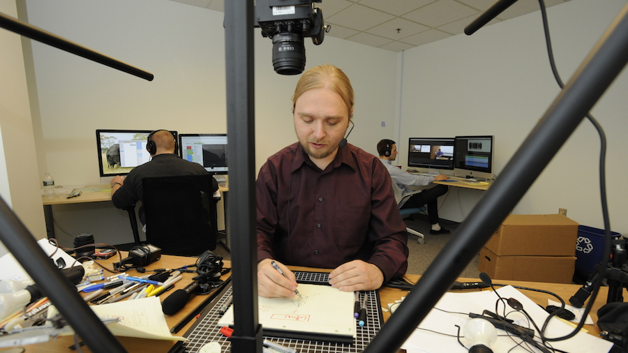 Piotr Mitros, Chief Scientist at edX, creates a video lecture using an overhead camera